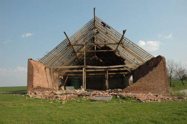 Das Foto zeigt die Scheune des Hofes Obenmetzkes mit eingedrücktem Giebel und abgedecktem Dach